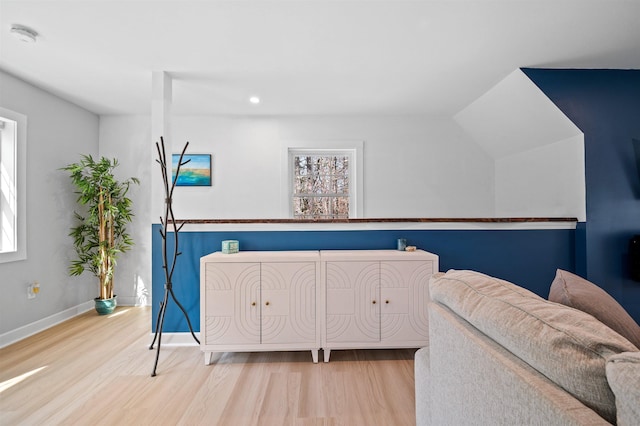 interior space featuring wood finished floors, baseboards, recessed lighting, and multiple windows