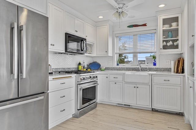 46A River St Unit A, Seabrook, NH 03874 - kitchen with stainless steel appliances, light countertops, white cabinets, and a sink