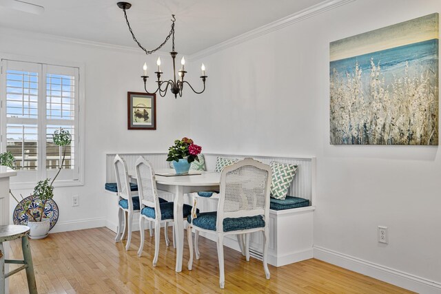 46A River St Unit A, Seabrook, NH 03874 - dining area featuring wood finished floors, a chandelier, ornamental molding, and baseboards