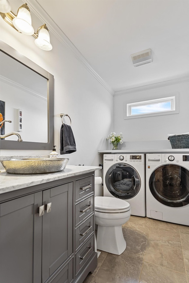 46A River St Unit A, Seabrook, NH 03874 - bathroom with washer and dryer, ornamental molding, toilet, vanity, and visible vents