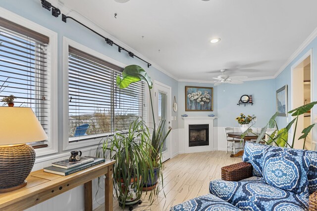 46A River St Unit A, Seabrook, NH 03874 - living room featuring crown molding, light wood finished floors, ceiling fan, and a healthy amount of sunlight
