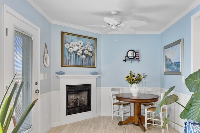 46A River St Unit A, Seabrook, NH 03874 - dining space with crown molding, a ceiling fan, wainscoting, and a fireplace