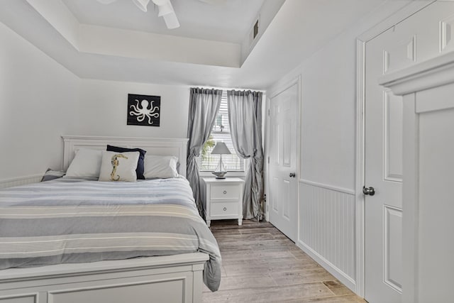 46A River St Unit A, Seabrook, NH 03874 - bedroom featuring visible vents, a tray ceiling, light wood finished floors, and a ceiling fan