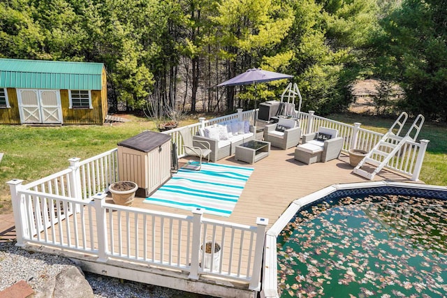 pool featuring a deck, an outdoor structure, a yard, a storage unit, and an outdoor hangout area