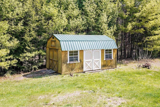 view of shed featuring a fire pit and a forest view