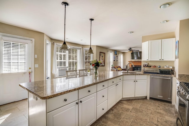 kitchen featuring white cabinetry, ceiling fan, appliances with stainless steel finishes, and plenty of natural light