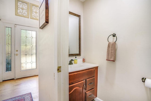 bathroom with vanity and wood finished floors