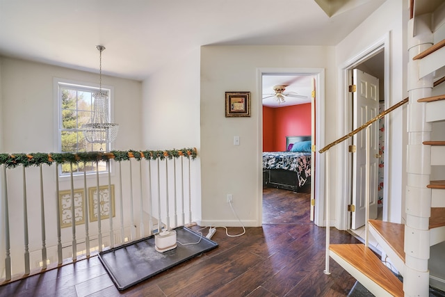 foyer entrance featuring wood finished floors, a ceiling fan, and baseboards
