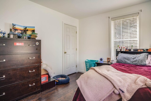 bedroom featuring dark wood-style flooring and baseboards