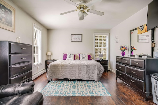 bedroom with a baseboard heating unit, a ceiling fan, multiple windows, and dark wood-type flooring