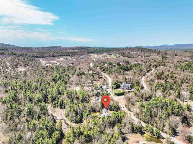 drone / aerial view featuring a forest view