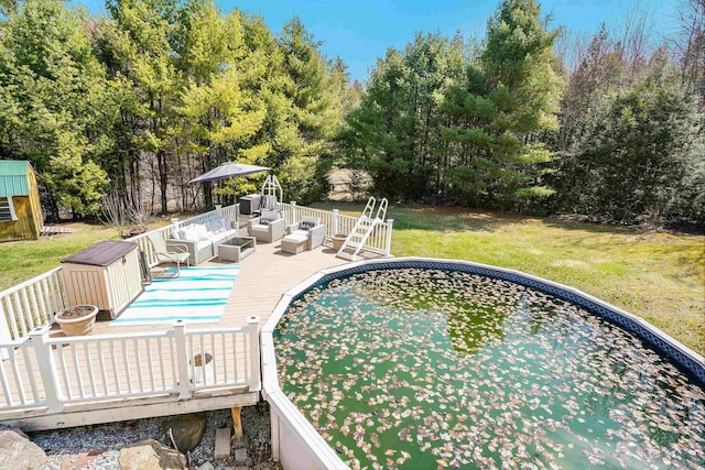 outdoor pool featuring a deck, an outdoor living space, and a lawn