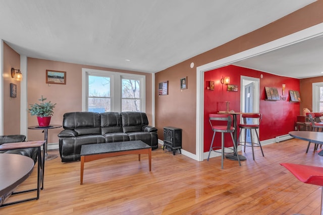 living room featuring a baseboard radiator, wood finished floors, baseboard heating, and baseboards