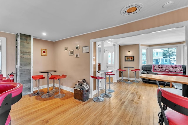living room with decorative columns, baseboards, recessed lighting, and wood-type flooring
