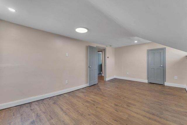 interior space featuring recessed lighting, wood finished floors, and baseboards