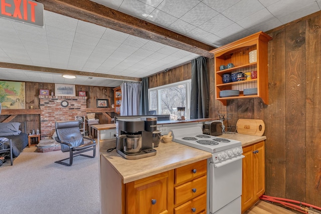 kitchen featuring beam ceiling, white electric range oven, open shelves, wooden walls, and light countertops