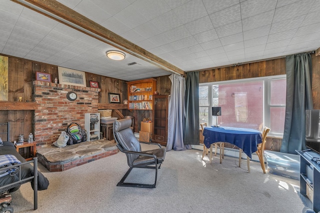 carpeted living area featuring wooden walls