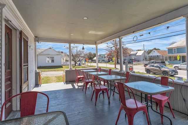 sunroom / solarium with outdoor dining space and a residential view