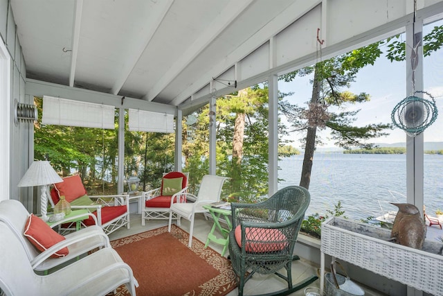 sunroom featuring a water view and beam ceiling