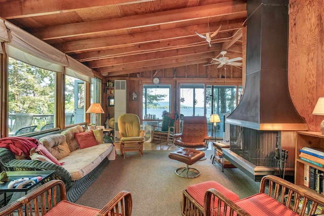 interior space with a ceiling fan, wood ceiling, carpet flooring, and vaulted ceiling