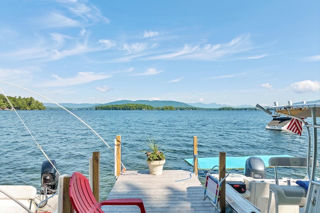 view of dock featuring a water and mountain view