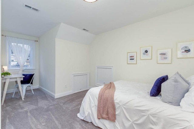 carpeted bedroom with visible vents and baseboards