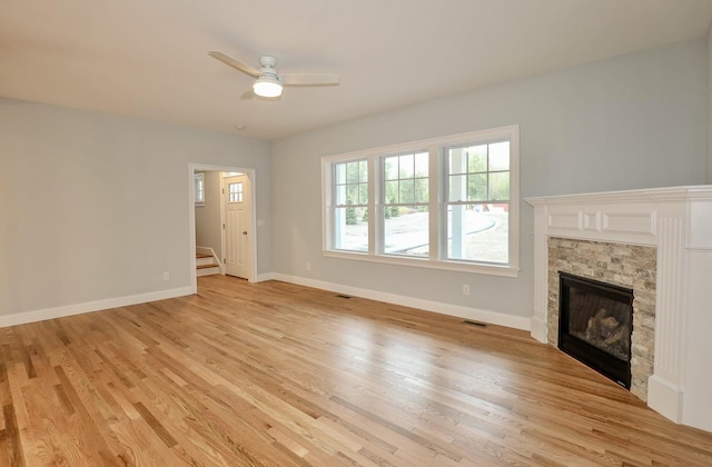 unfurnished living room with light wood-style floors, a ceiling fan, visible vents, and baseboards