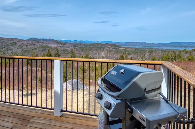 deck with area for grilling and a mountain view