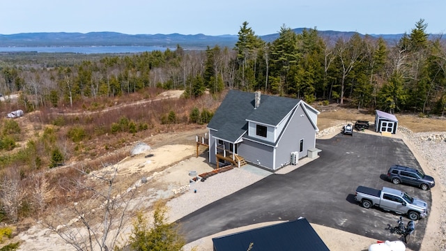 birds eye view of property with a mountain view and a view of trees
