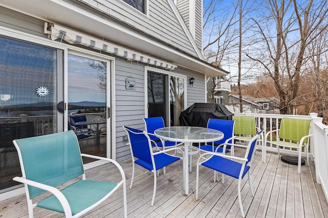 wooden deck featuring outdoor dining area