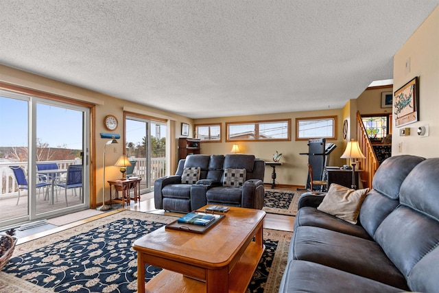 living area with wood finished floors and a textured ceiling