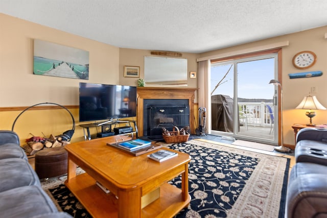 living area featuring a textured ceiling and a fireplace