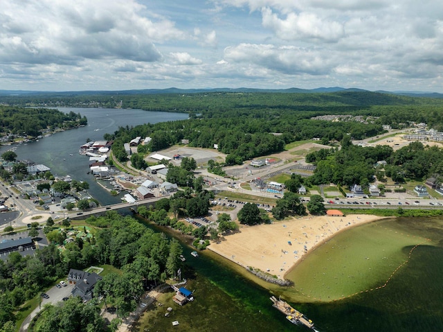 aerial view featuring a wooded view and a water view