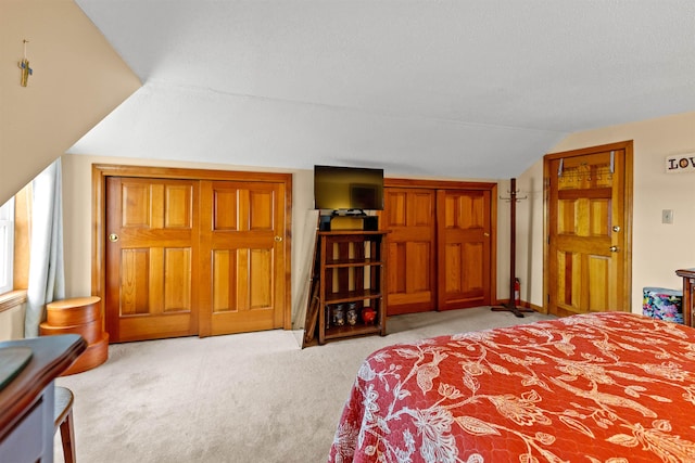 bedroom with carpet and vaulted ceiling
