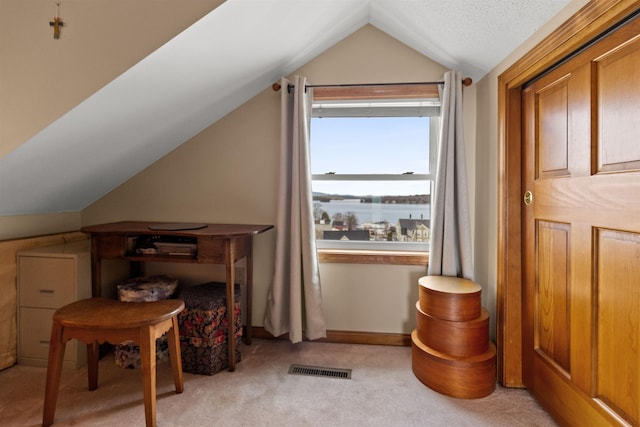 bonus room featuring lofted ceiling and light carpet