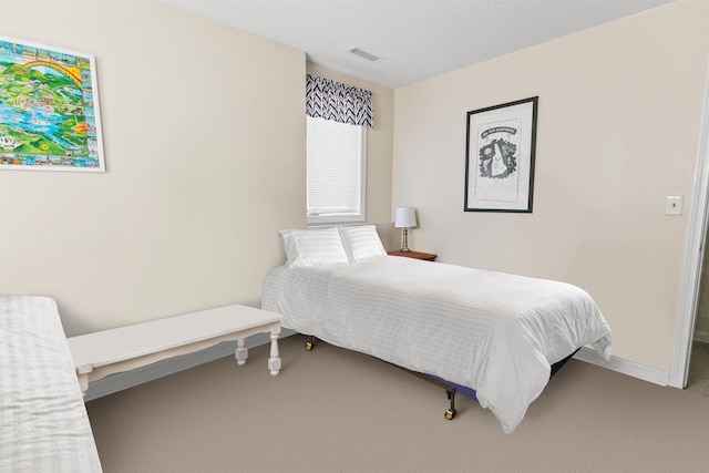 bedroom with baseboards, visible vents, and carpet flooring