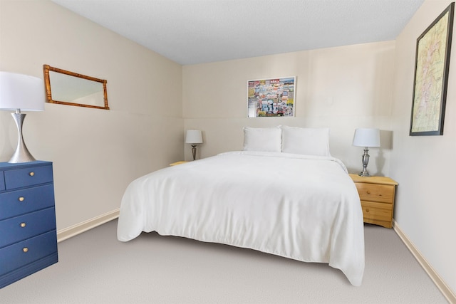 carpeted bedroom with baseboards