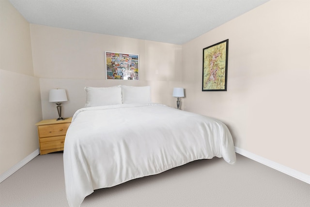 bedroom featuring light colored carpet and baseboards