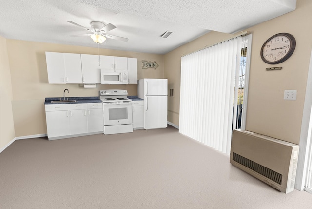 kitchen with a sink, white cabinetry, light carpet, and white appliances