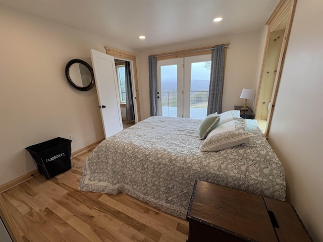 bedroom with light wood-type flooring, recessed lighting, access to outside, and baseboards