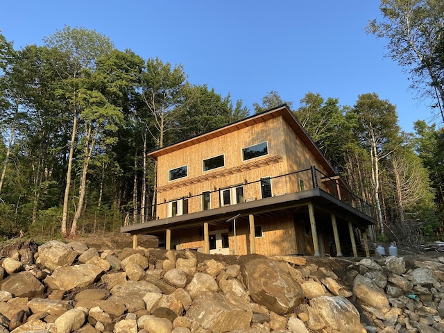 back of property with a view of trees