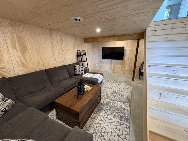 living area with visible vents, wood walls, concrete flooring, and wood ceiling