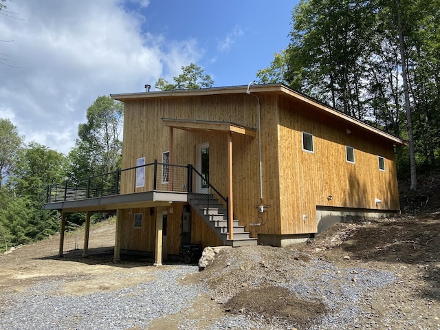 exterior space featuring stairs and a wooden deck