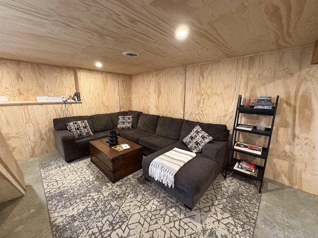 living room featuring visible vents and wood walls
