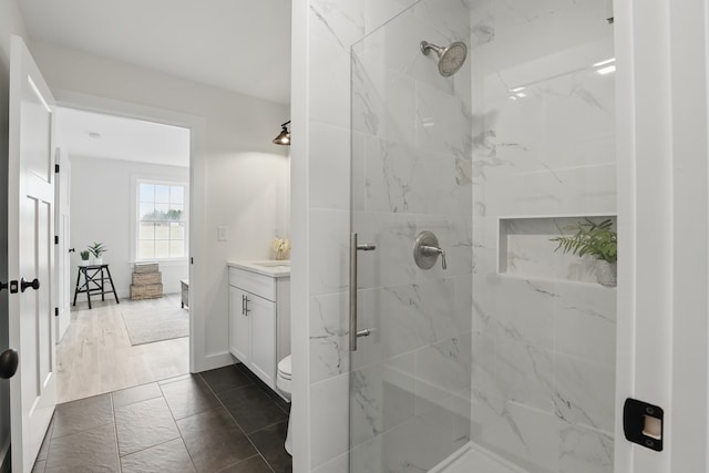 full bathroom featuring a marble finish shower and vanity