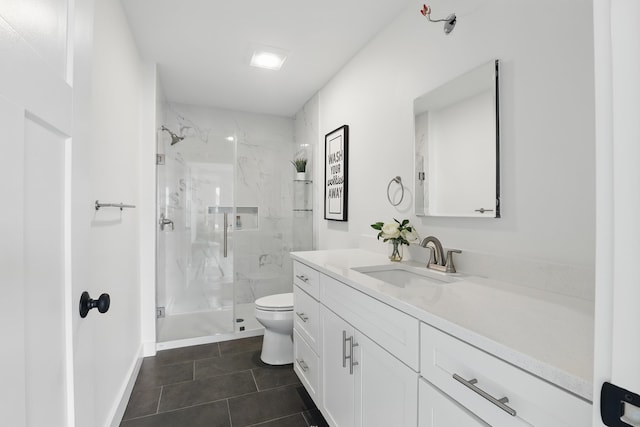 bathroom with tile patterned flooring, toilet, vanity, baseboards, and a marble finish shower