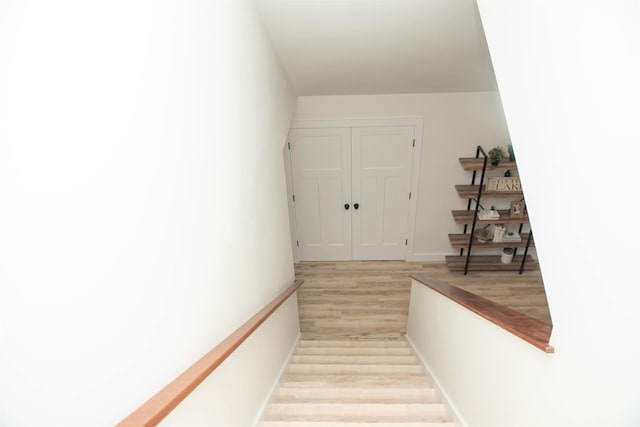 staircase with wood finished floors