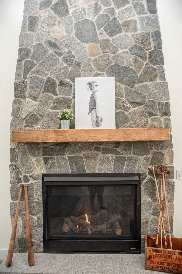 interior details with a glass covered fireplace