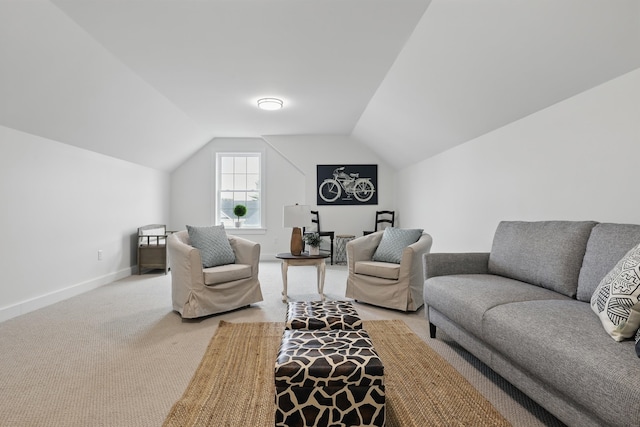 living area with lofted ceiling, light colored carpet, and baseboards