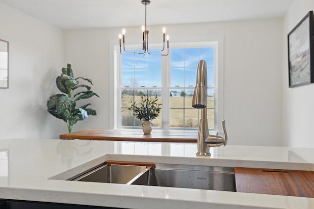 details with pendant lighting, a chandelier, and a sink